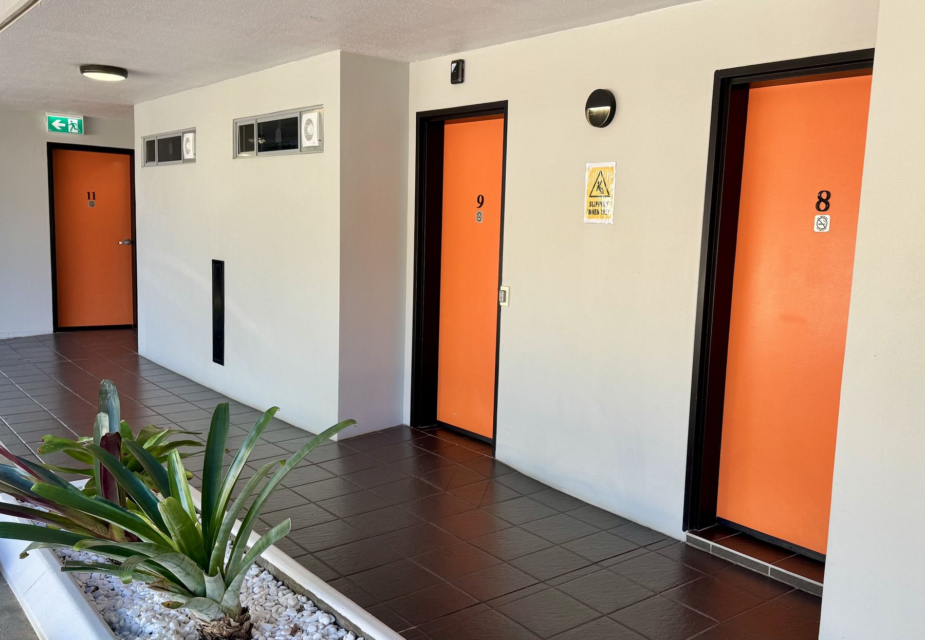 Signature orange doors along the motel walkway